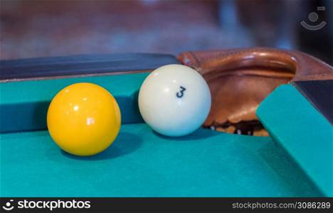 Green billiard table with white balls. Ball at the hole. Closeup . game of billiards
