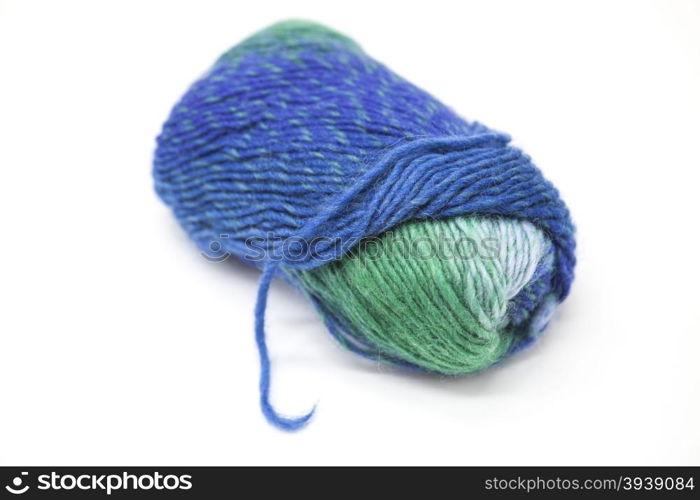 Green blue ball of wool yarn for knitting close up on a white background.. Green blue ball of wool yarn for knitting close up on a white background
