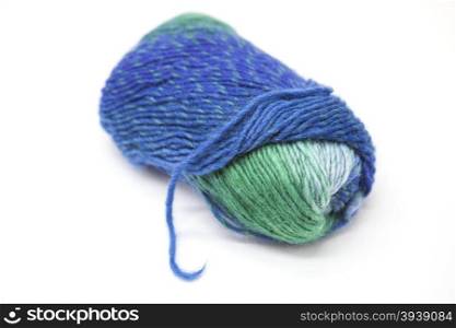 Green blue ball of wool yarn for knitting close up on a white background.. Green blue ball of wool yarn for knitting close up on a white background