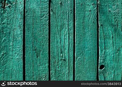 Green blue painted wooden board fence wall surface closeup as background