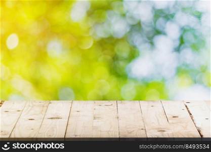 green bokeh and soft light in garden and wood table with space