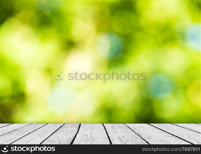 Green bokeh and sunlight and wood floor. Beauty natural background
