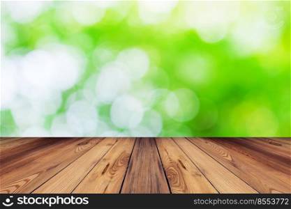 Green bokeh blur background and wood table in garden