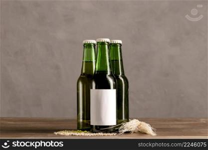 green bottles white label wooden table