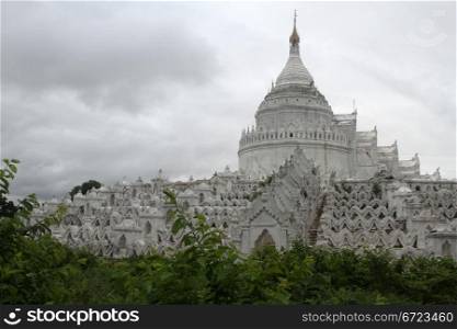 Green bush and white stupa in Mingun, Mandalay, Myanmar