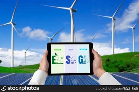 Green business transformation for environment saving and ESG business concept. Businessman using tablet to set corporate goal toward environmental friendly management and alternative clean energy use.. Green business transformation for environment saving and ESG business concept