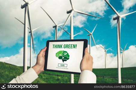 Green business transformation for environment saving and ESG business concept. Businessman using tablet to set corporate goal toward environmental friendly management and alternative clean energy use.. Green business transformation for environment saving and ESG business concept