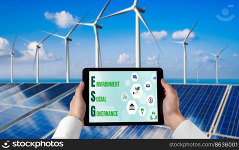 Green business transformation for environment saving and ESG business concept. Businessman using tablet to set corporate goal toward environmental friendly management and alternative clean energy use.. Green business transformation for environment saving and ESG business concept