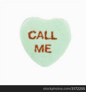 Green candy heart that reads call me against white background.