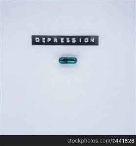 green capsule with depression label grey background