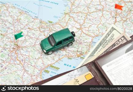 green car and leather wallet on the map of Europe