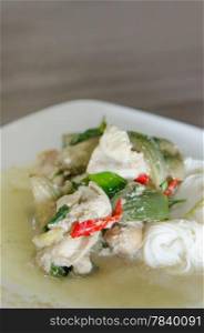 green chicken curry served with rice vermicelli in white plate