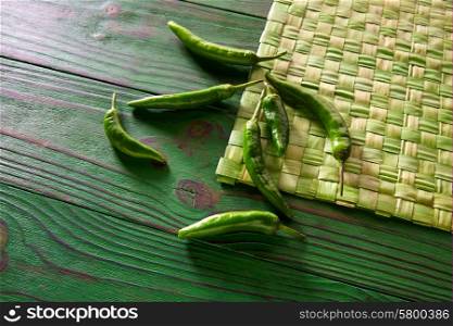 Green chili peppers in monochrome rustic table background