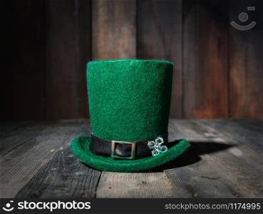 green classic leprechaun bowler hat on old wooden table in a pub