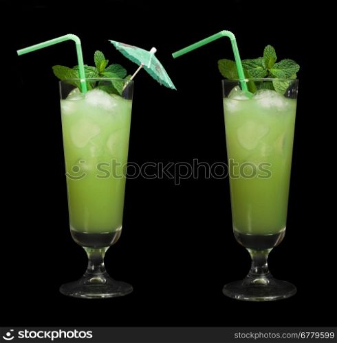 Green cocktail with cubes ice. Black isolated glass.