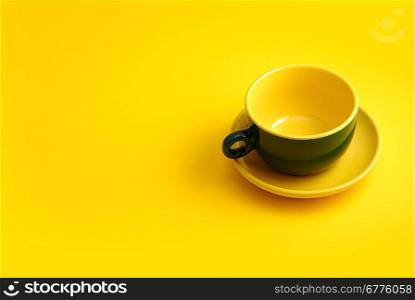 green cooffee cup on yellow background