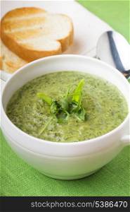 green cream soup with spinach and bread