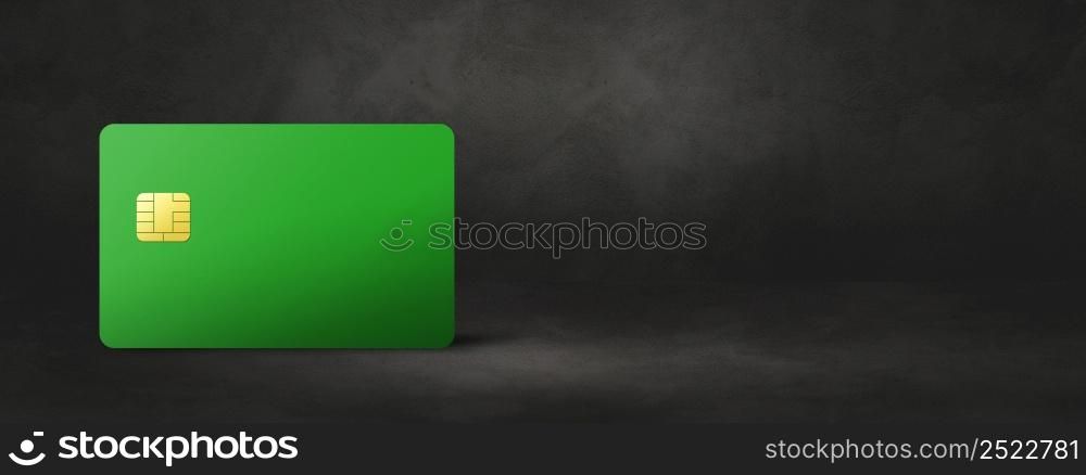 Green credit card template on a black concrete background banner. 3D illustration. Green credit card on a black concrete background