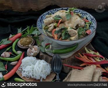 Green curry with Chicken and Green-white varieties of Thai eggplants  Kaeng khiao wan  in Ceramic bowl served with Thai rice noodles  Fermented rice flour noodles . Authentic thai food, Selective focus.