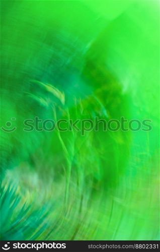Green defocused dynamic abstract background. Long time exposure motion blur. Green blurred bokeh background with motion effect.