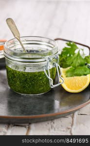 Green delicious herbal marinade of cilantro, basil, parsley, oil, traditional seasoning for salad dressing