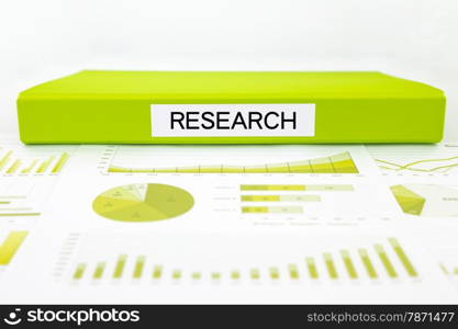 Green document binder with research word place on graph analysis, survey report, and statistic summary for business planning