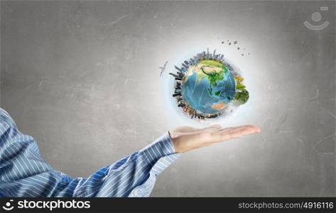 Green Earth planet in palm. Close up of human hands holding Earth planet. Elements of this image are furnished by NASA
