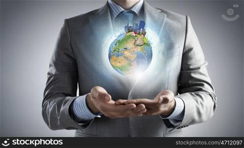 Green eco planet. Businessman hands holding Earth planet. Elements of this image are furnished by NASA