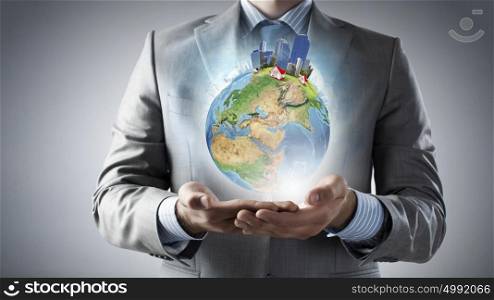 Green eco planet. Businessman hands holding Earth planet. Elements of this image are furnished by NASA