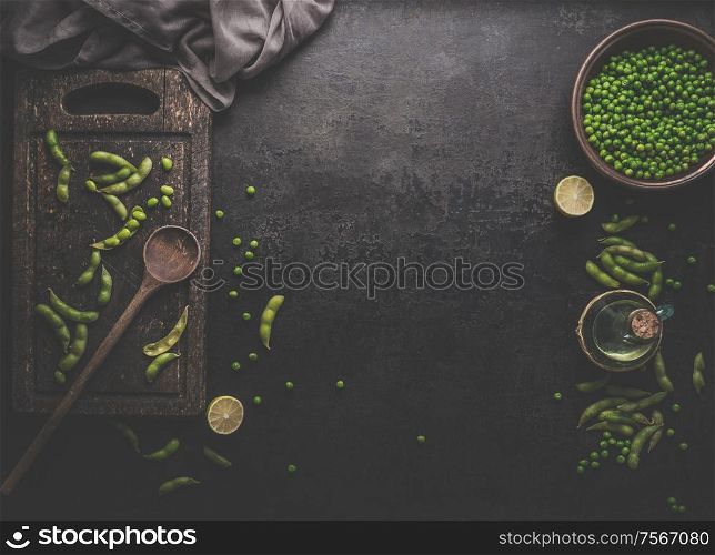 Green Edamame soybeans and green peas on dark rustic background. Healthy food cooking concept. Top view