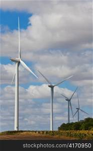 Green Energy Wind Turbines In Field of Sunflowers