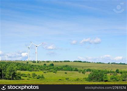 Green energy windmill generators ecology countryside blue sky