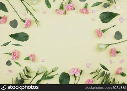green eucalyptus populus leaves pink carnations eustoma flowers with space center yellow background