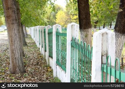 green fence autumn park