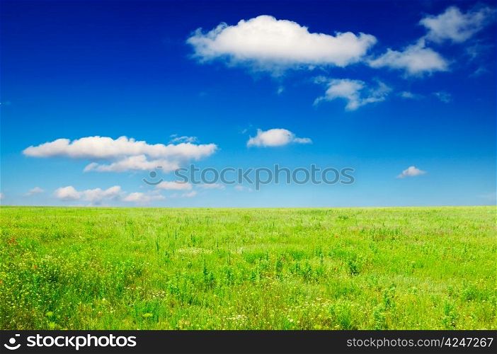 green field and beautiful clouds