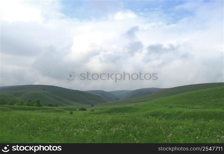 Green field and blue sky and white clouds