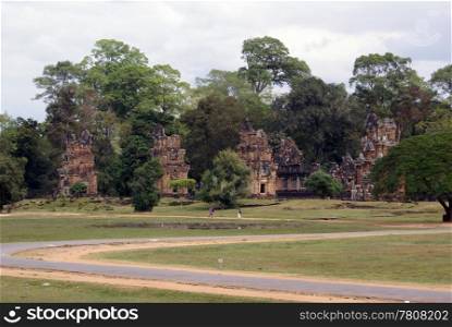 Green field and red temples, Angkor, Cambodia