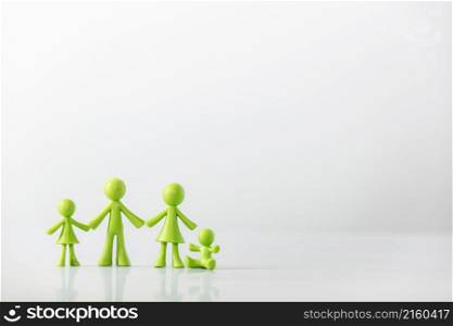 Green figures made of biodegradable plastic model of family with children - family relationship concept. Green figures made of biodegradable plastic model of family with children