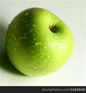 green fresh apple and waterdrops from it