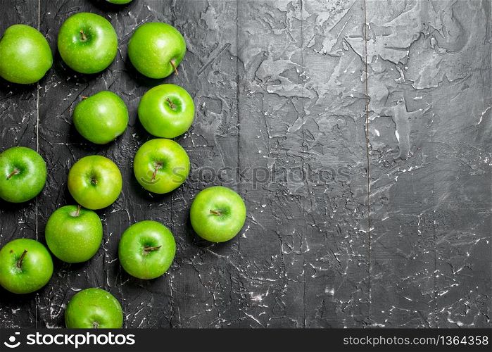 Green fresh apples. On a dark rustic background.. Green fresh apples.