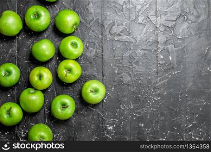 Green fresh apples. On a dark rustic background.. Green fresh apples.