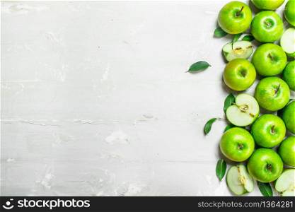 Green fresh apples. On white rustic background .. Green fresh apples.