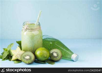 green fruit smoothie juice blue background