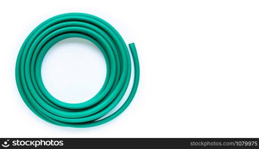 Green garden hose on white background. Copy space