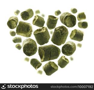 Green granulated hops in the shape of a heart on a white background.. Green granulated hops in the shape of a heart on a white background