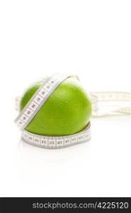 green grapefruit and measure tape isolated on white
