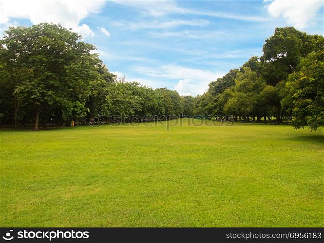 Green grass green trees in beautiful park white Cloud blue sky in noon.. Green grass green trees in beautiful park