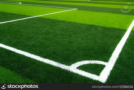 Green grass soccer field. Empty artificial turf football field with white line. View from the corner of soccer field. Sport background