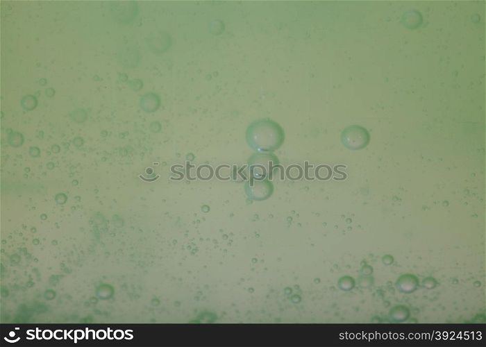 Green gray abstract blurred liquid background with soap bubbles
