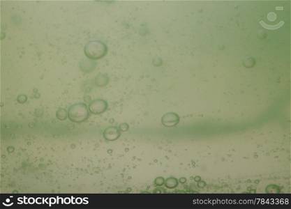 Green gray abstract blurred liquid background with soap bubbles
